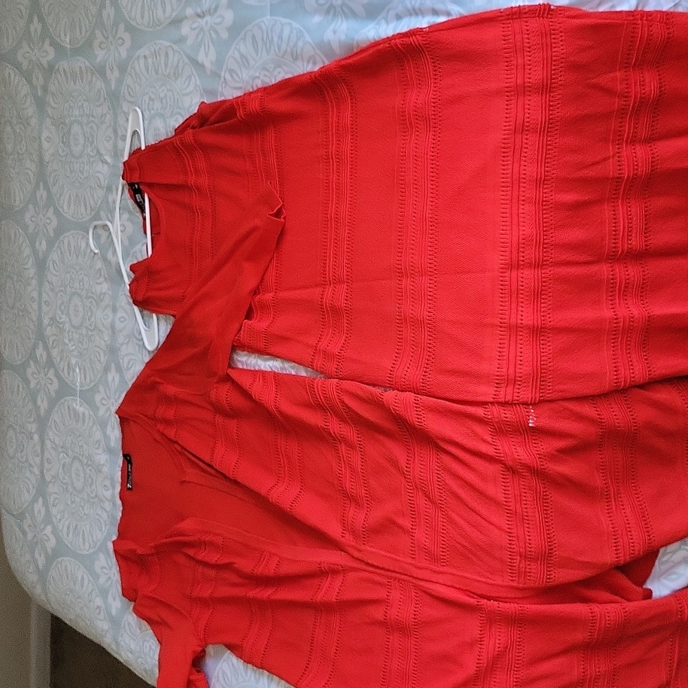 Sleeveless dress with over long sweater.